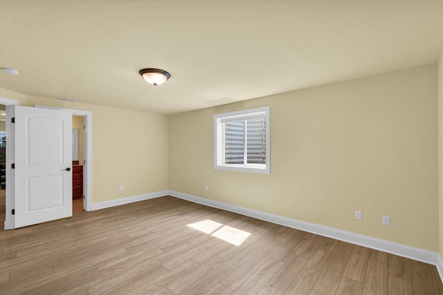unfurnished bedroom with baseboards, light wood-type flooring, and visible vents