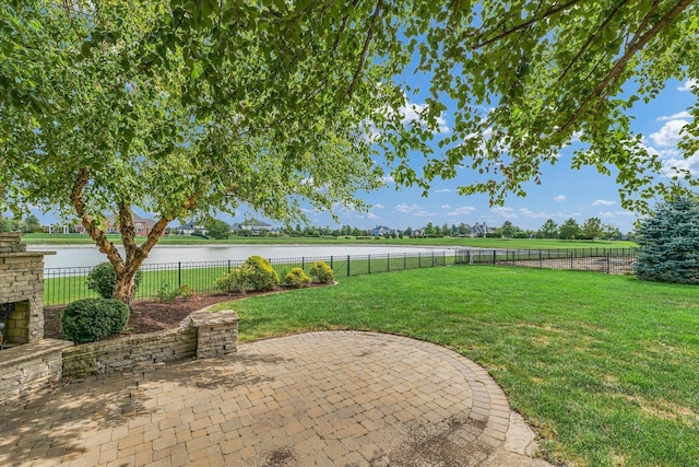 view of patio with a water view and a fenced backyard