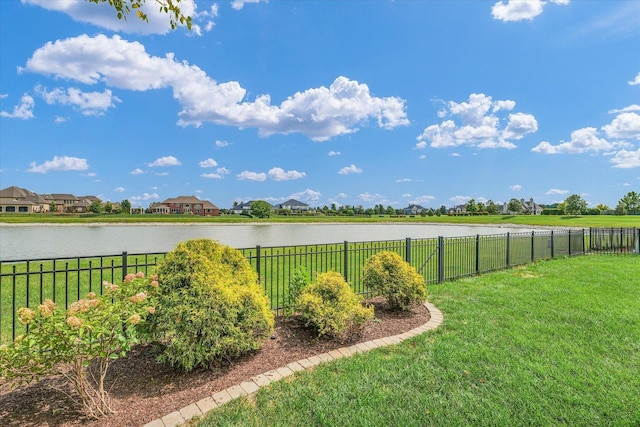 view of yard with a water view and a fenced backyard