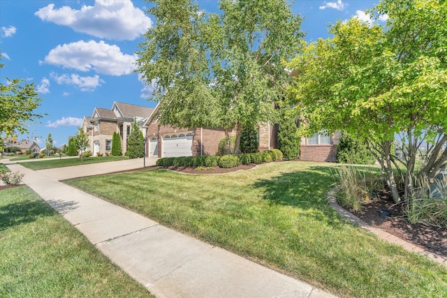 view of front of home featuring brick siding, a front lawn, and driveway