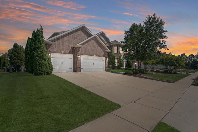 view of front of property with a yard and a garage