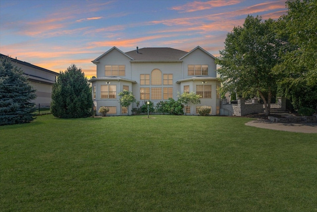 rear view of property with a lawn