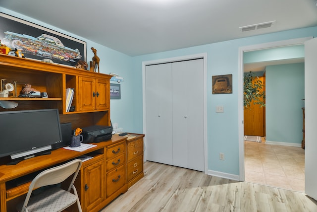 office with light hardwood / wood-style flooring