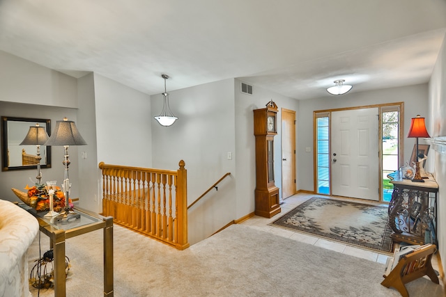 view of carpeted foyer entrance