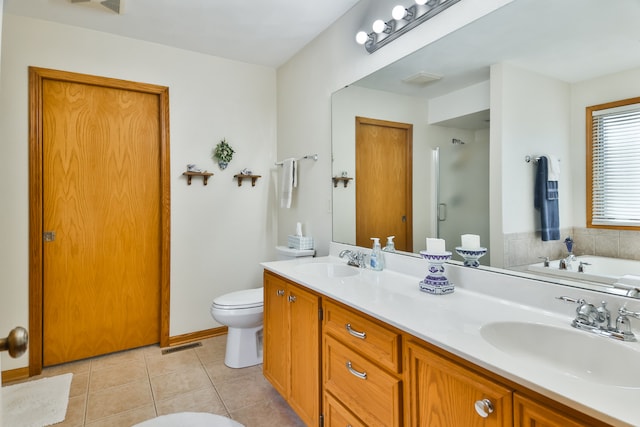 bathroom featuring vanity, toilet, tile patterned floors, and a bathtub