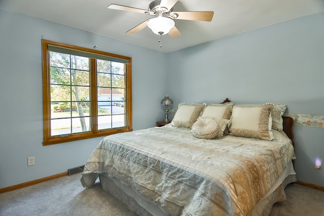 bedroom with ceiling fan and carpet