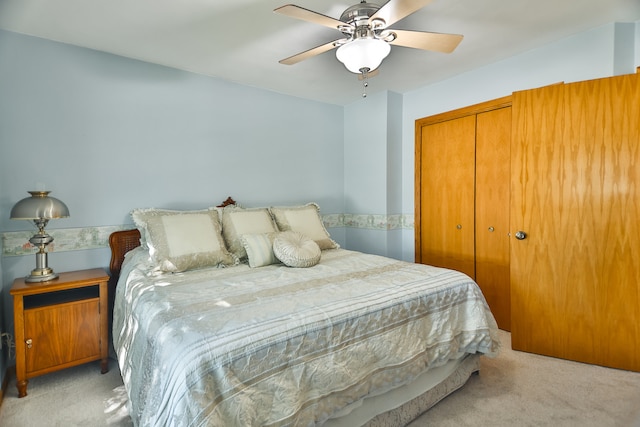 bedroom featuring a closet, ceiling fan, and light colored carpet