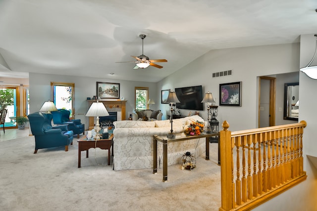 carpeted living room featuring lofted ceiling, a wealth of natural light, and ceiling fan