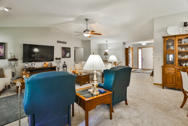 living room with ceiling fan, light carpet, and vaulted ceiling