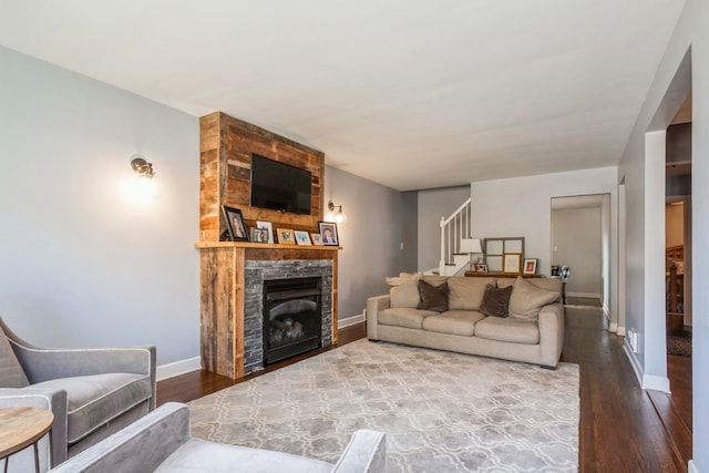 living room with hardwood / wood-style floors and a fireplace