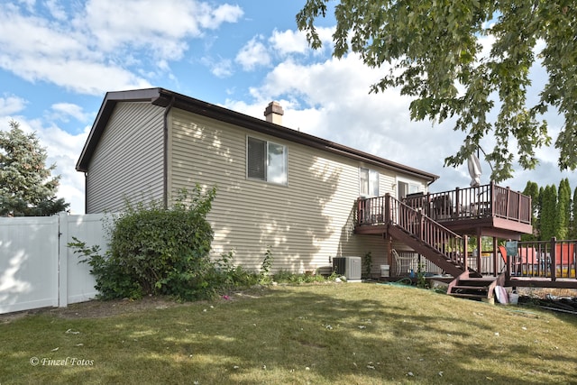 back of house with a yard, central AC, and a deck