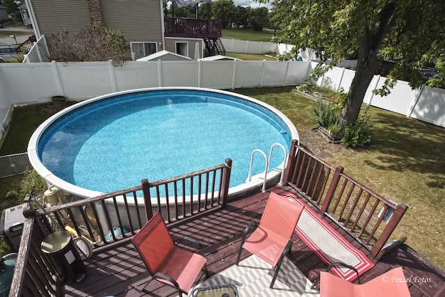 view of pool featuring a yard and a deck