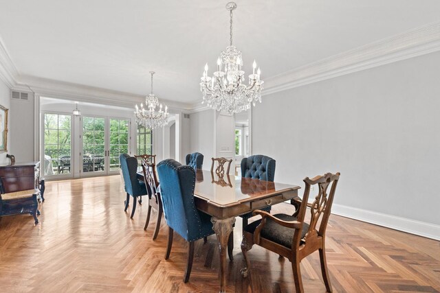 dining area featuring a healthy amount of sunlight, an inviting chandelier, and light parquet flooring