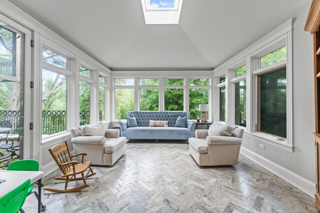 sunroom / solarium featuring vaulted ceiling with skylight