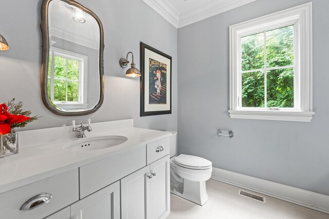 bathroom featuring toilet, ornamental molding, and vanity