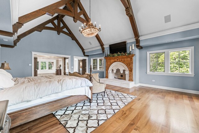 bedroom with beamed ceiling, high vaulted ceiling, hardwood / wood-style floors, and an inviting chandelier