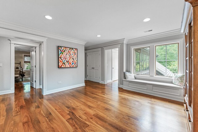 unfurnished bedroom with ornamental molding and wood-type flooring