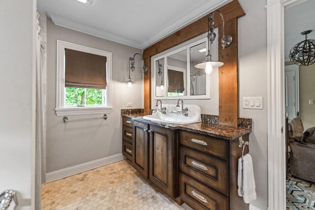 bathroom with ornamental molding and vanity