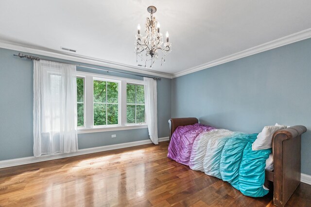 bedroom with ornamental molding, dark hardwood / wood-style flooring, and an inviting chandelier