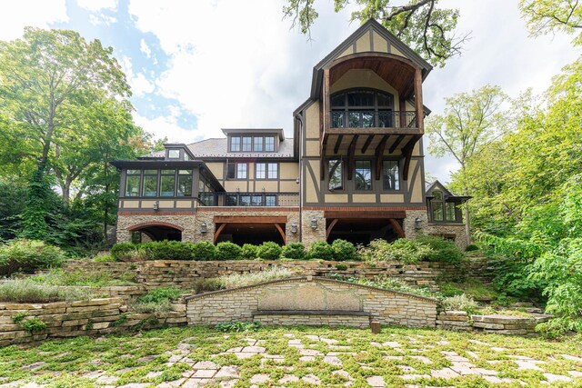 rear view of property featuring a balcony