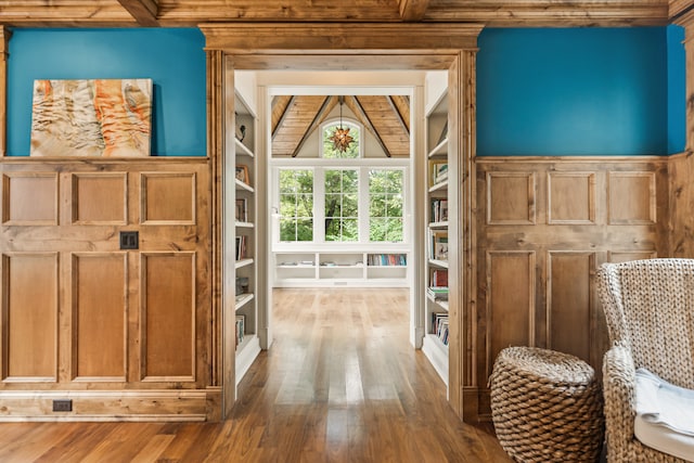 interior space featuring built in shelves and hardwood / wood-style flooring