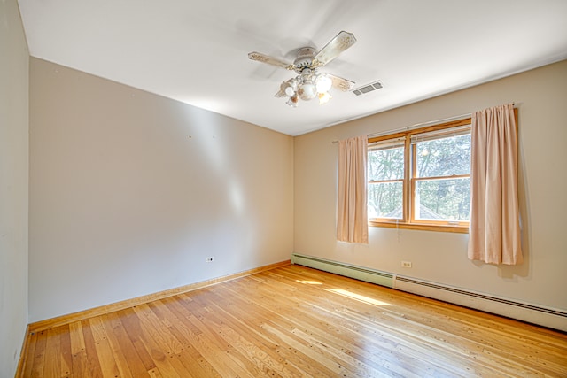 empty room featuring a baseboard radiator, ceiling fan, and light hardwood / wood-style flooring