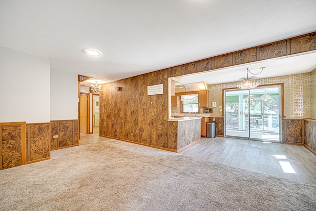 spare room with hardwood / wood-style floors and a chandelier