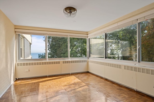 unfurnished sunroom with a water view