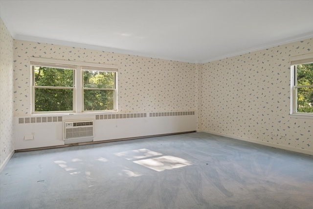 empty room with carpet floors, ornamental molding, an AC wall unit, and radiator heating unit