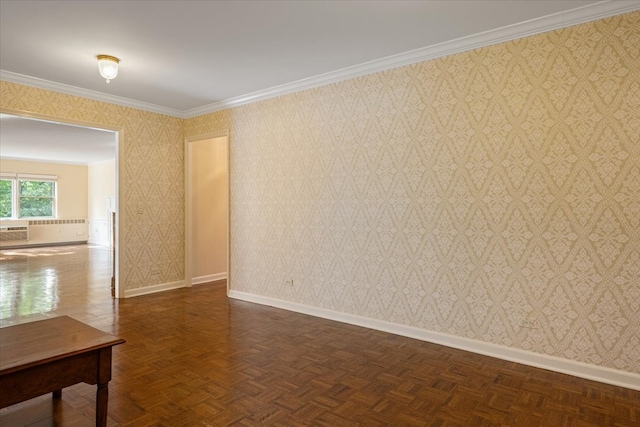 spare room featuring crown molding and dark parquet floors