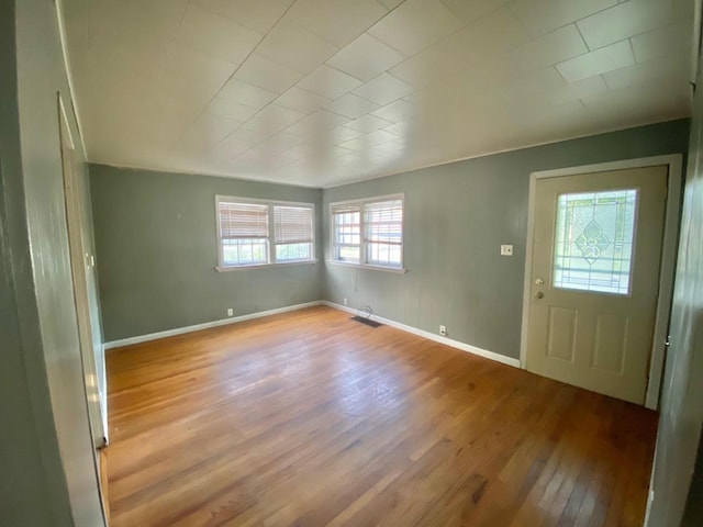 foyer featuring wood finished floors and baseboards