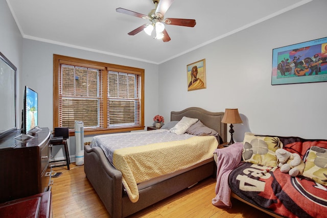 bedroom with light wood-type flooring, ceiling fan, and crown molding