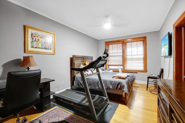 bedroom featuring ceiling fan, light wood-type flooring, and baseboards