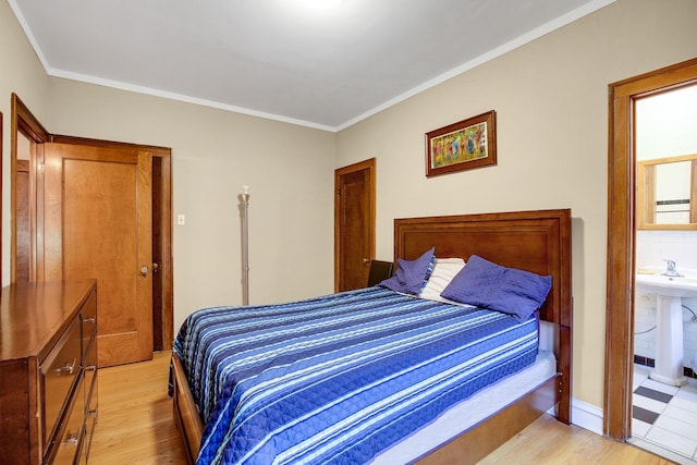 bedroom with light wood-style floors and ornamental molding