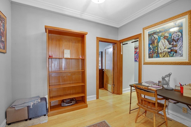 hall featuring crown molding, baseboards, and light wood-type flooring