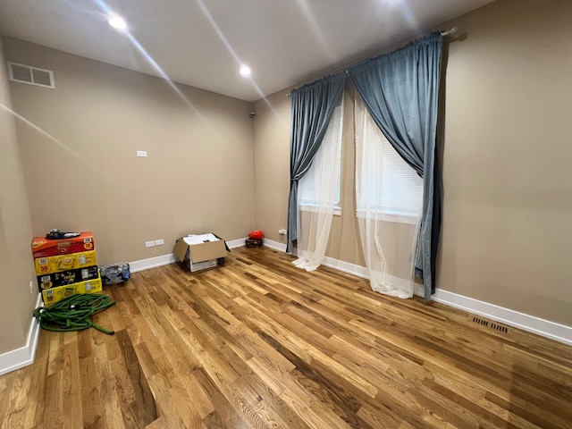 recreation room with wood-type flooring