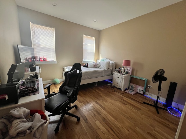 bedroom with dark hardwood / wood-style floors