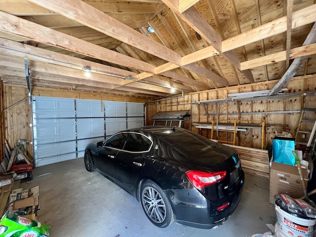 garage featuring wood walls