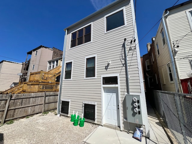 back of house with a wooden deck