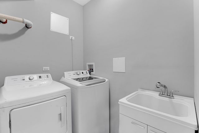 washroom featuring sink and independent washer and dryer