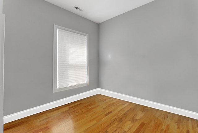 empty room with hardwood / wood-style floors