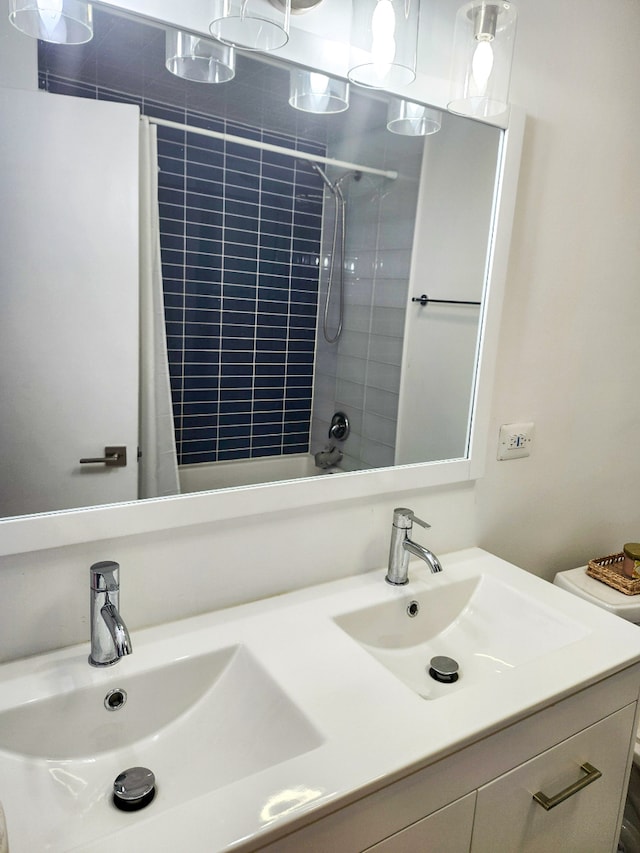 bathroom with walk in shower and vanity