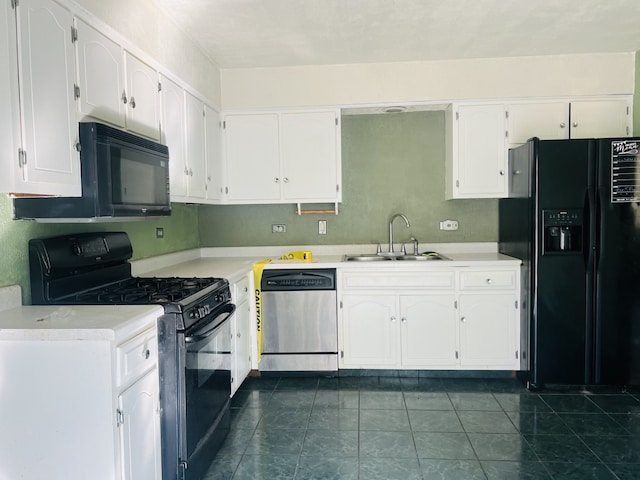 kitchen with white cabinets, sink, black appliances, and dark tile patterned flooring