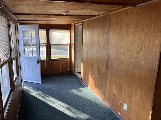 unfurnished sunroom featuring beam ceiling and wood ceiling