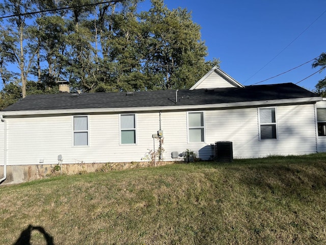 view of property exterior featuring central AC and a yard