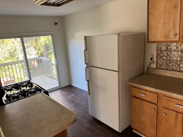 kitchen featuring white fridge and dark hardwood / wood-style flooring