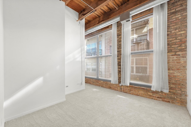 carpeted spare room with brick wall, beam ceiling, and wooden ceiling