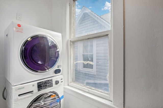 laundry room with stacked washing maching and dryer