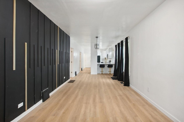 hallway with light wood-type flooring