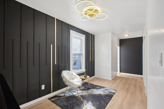 sitting room with light wood-type flooring and baseboards